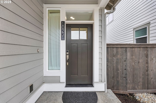 property entrance with elevator and fence