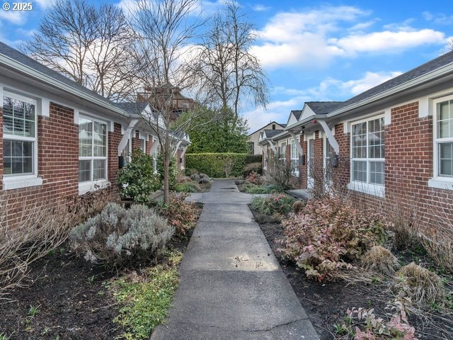 exterior space featuring brick siding and a residential view