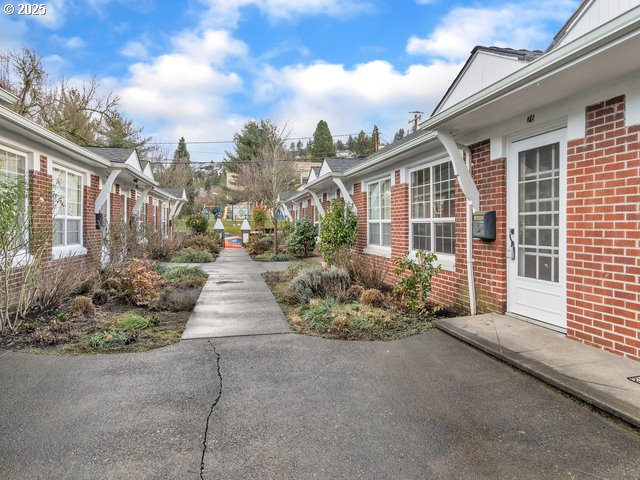 view of property exterior with brick siding and a residential view