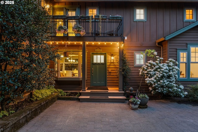 doorway to property with board and batten siding and a balcony