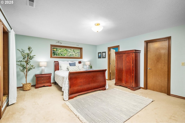 bedroom with baseboards, visible vents, a textured ceiling, and light colored carpet
