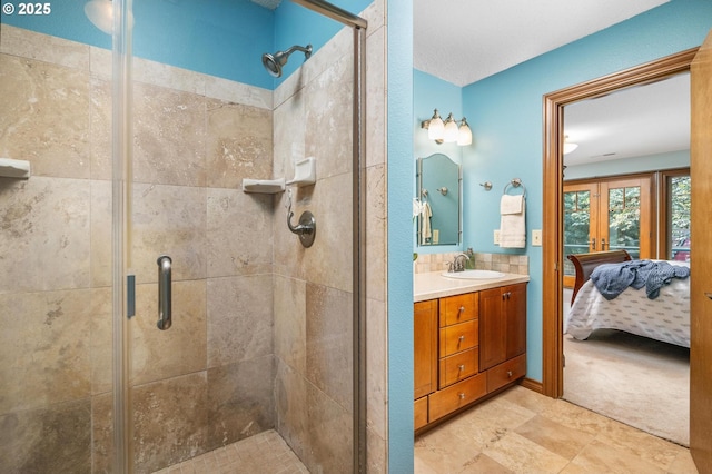 bathroom with french doors, vanity, ensuite bathroom, and a shower stall
