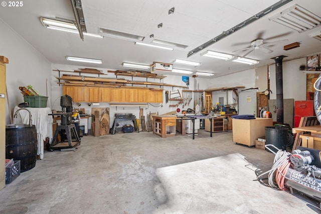 garage featuring ceiling fan and a workshop area