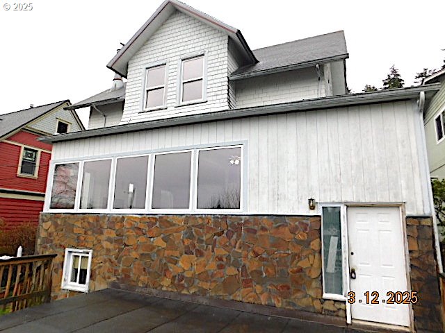 back of property with stone siding