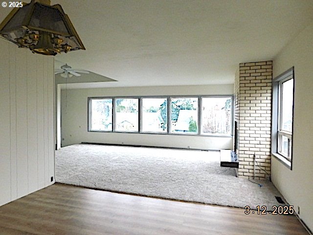 interior space with wood finished floors and a wealth of natural light