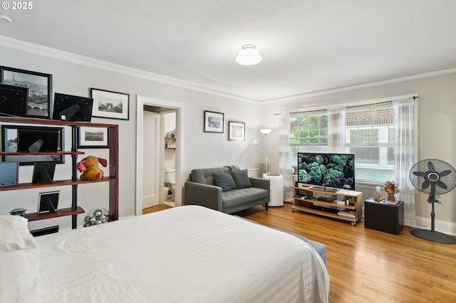 1509 NE 10th Ave Unit 105, Portland, OR 97232 - bedroom with ornamental molding, wood finished floors, and connected bathroom