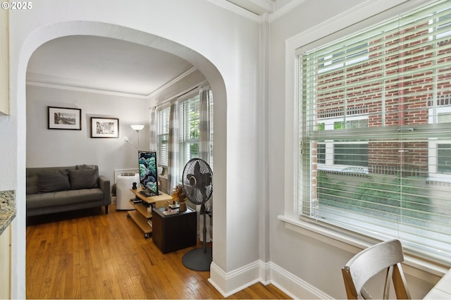 1509 NE 10th Ave Unit 105, Portland, OR 97232 - living area with arched walkways, ornamental molding, and hardwood / wood-style floors