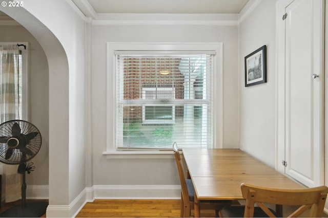 1509 NE 10th Ave Unit 105, Portland, OR 97232 - dining space featuring arched walkways, wood finished floors, and ornamental molding