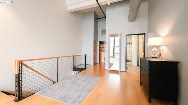 1400 NW Irving St Unit 715, Portland, OR 97209 - hallway with light wood finished floors and a towering ceiling