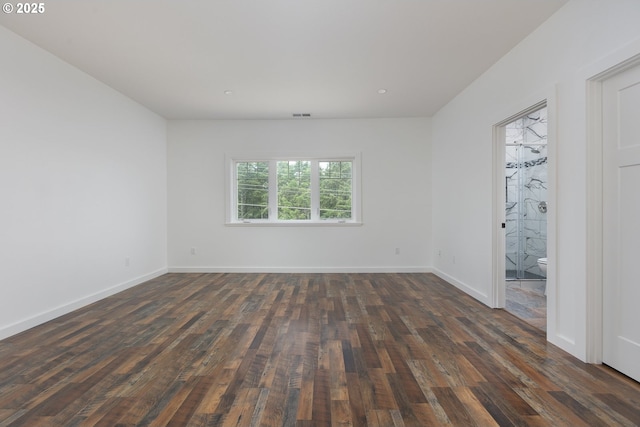 spare room featuring dark hardwood / wood-style floors