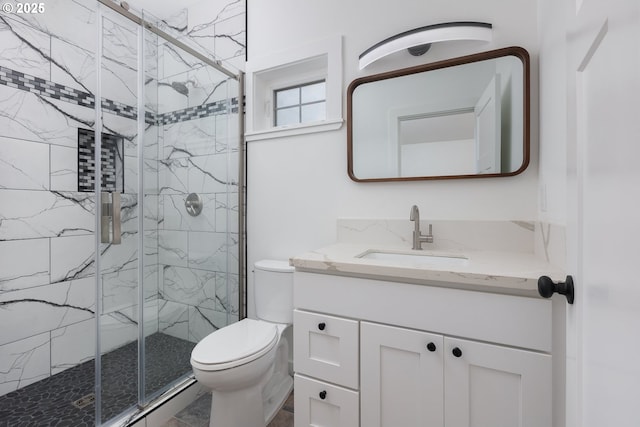 bathroom with vanity, an enclosed shower, and toilet