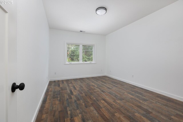 unfurnished room featuring dark hardwood / wood-style floors