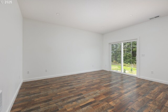 spare room featuring dark hardwood / wood-style floors