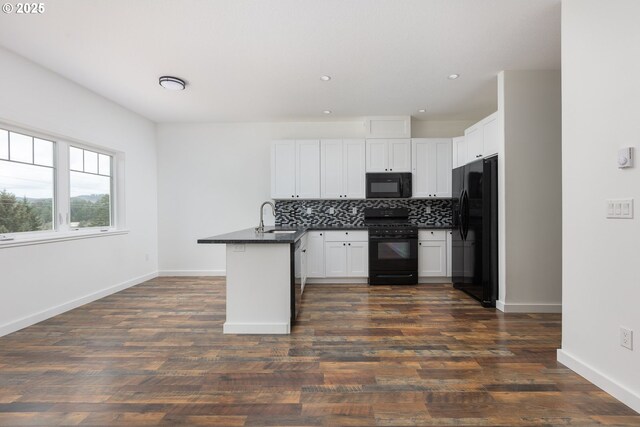 kitchen featuring tasteful backsplash, black appliances, sink, white cabinets, and kitchen peninsula