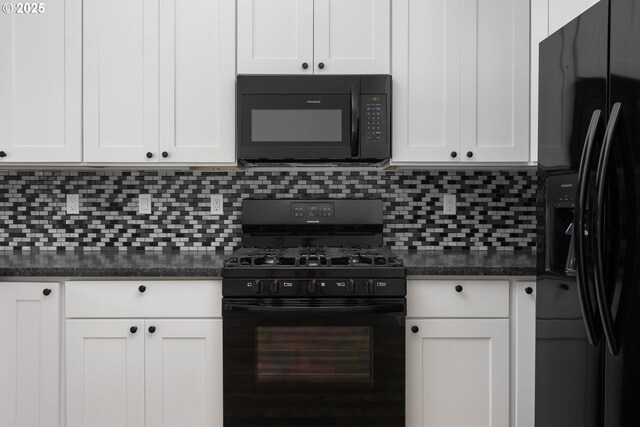 kitchen featuring white cabinetry, dark stone countertops, backsplash, and black appliances