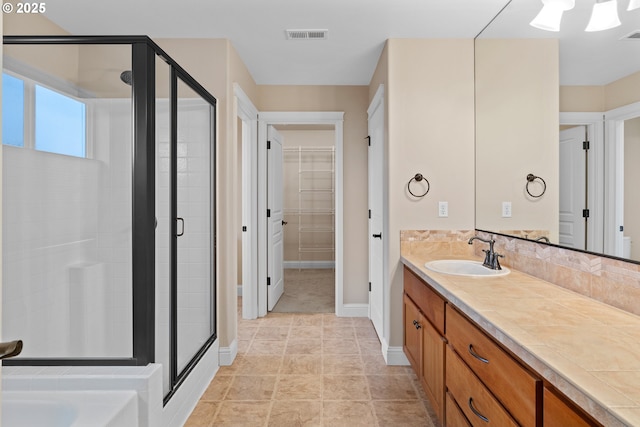 bathroom with vanity and an enclosed shower