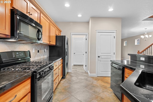 kitchen with sink, a notable chandelier, backsplash, light tile patterned flooring, and black appliances