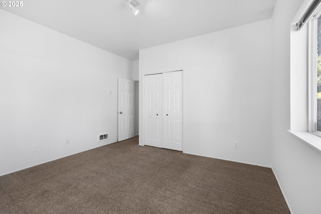2689 Cupola Dr, Eugene, OR 97403 - unfurnished bedroom featuring dark colored carpet and a closet