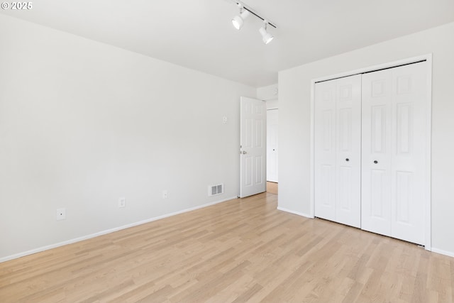 2689 Cupola Dr, Eugene, OR 97403 - unfurnished bedroom with light wood-type flooring, track lighting, and a closet