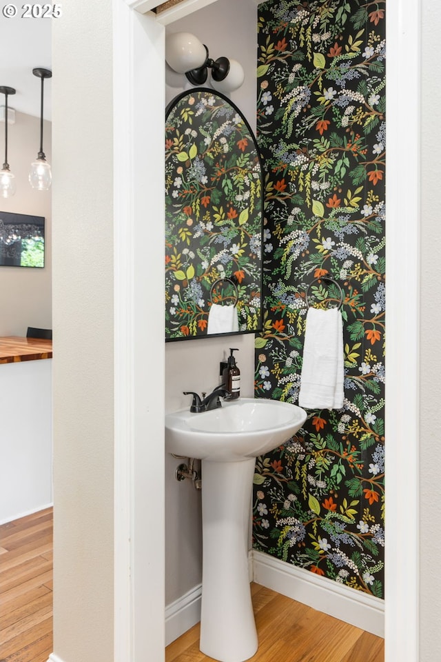 17 S Curry St, Portland, OR 97239 - bathroom featuring wood finished floors, baseboards, and a sink