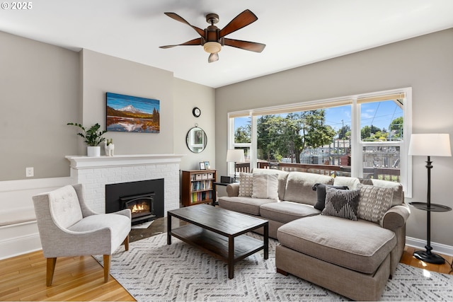 17 S Curry St, Portland, OR 97239 - living room featuring ceiling fan, light wood-style floors, a brick fireplace, and baseboards