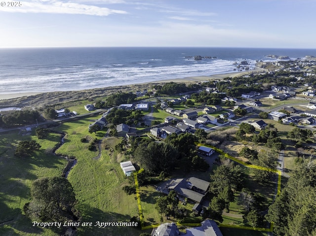 birds eye view of property with a view of the beach and a water view