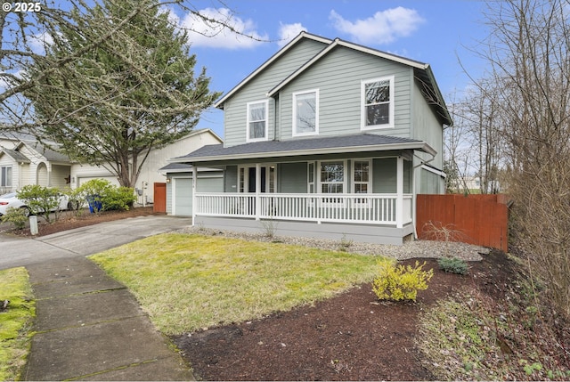 view of front of property with a garage, a front yard, and covered porch