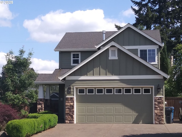 craftsman-style house with stone siding, a shingled roof, board and batten siding, and concrete driveway