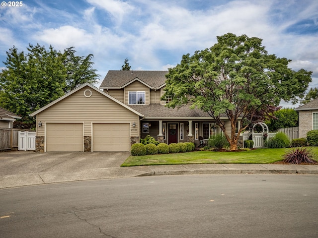 29643 SW Young Way, Wilsonville, OR 97070 - view of front of house featuring driveway, a garage, stone siding, and a porch