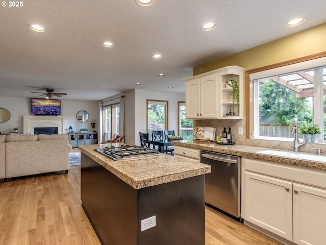 29643 SW Young Way, Wilsonville, OR 97070 - kitchen with appliances with stainless steel finishes, recessed lighting, a center island, tile counters, and light wood-type flooring