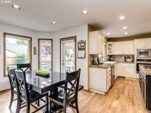 29643 SW Young Way, Wilsonville, OR 97070 - kitchen featuring stainless steel appliances, plenty of natural light, light wood-style flooring, recessed lighting, and white cabinetry