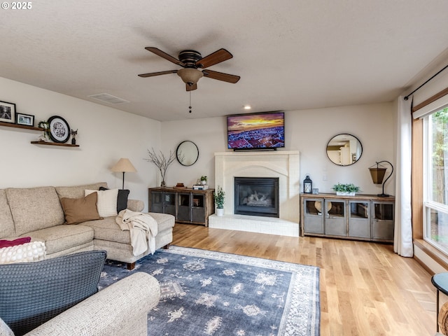 29643 SW Young Way, Wilsonville, OR 97070 - living room featuring wood finished floors, ceiling fan, and a fireplace
