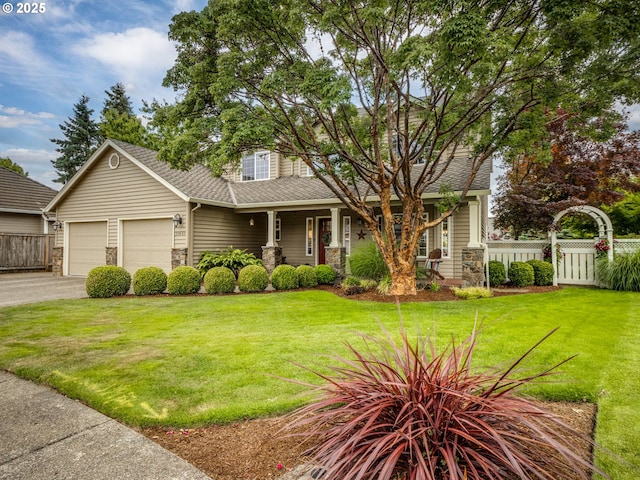 29643 SW Young Way, Wilsonville, OR 97070 - view of front of home featuring stone siding, asphalt driveway, an attached garage, a porch, and roof with shingles