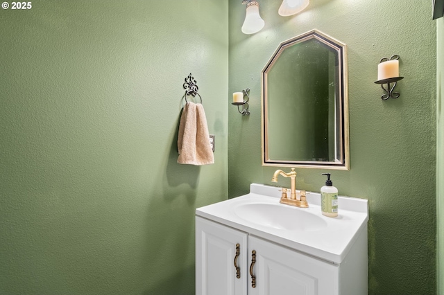 bathroom with a textured wall and vanity