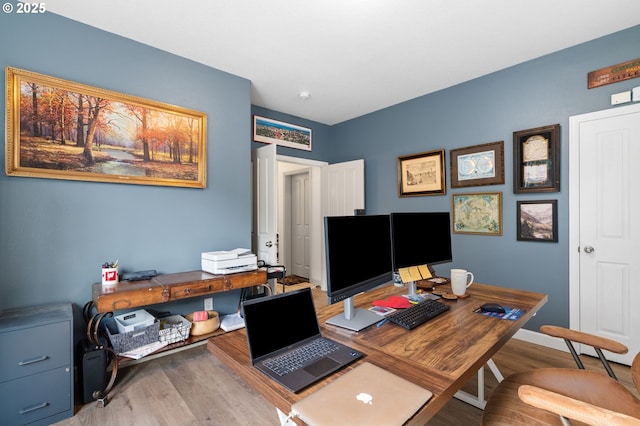 office featuring baseboards and wood finished floors