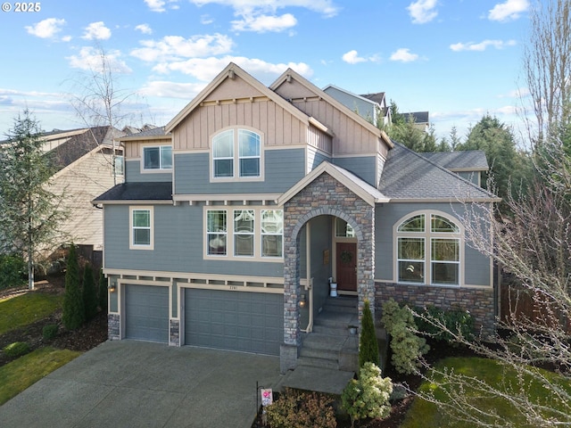 craftsman inspired home featuring driveway, stone siding, board and batten siding, and an attached garage