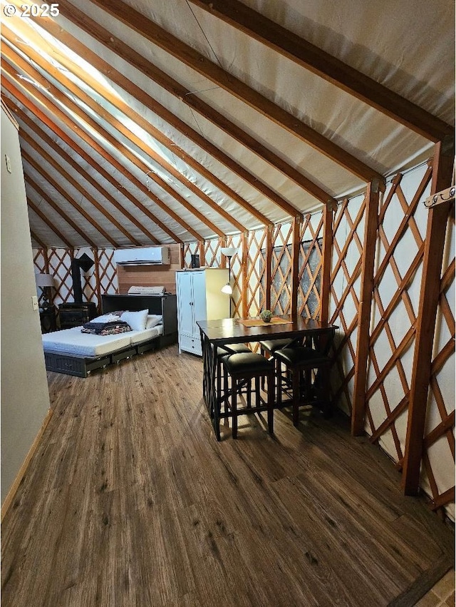additional living space with dark wood-style flooring and an AC wall unit