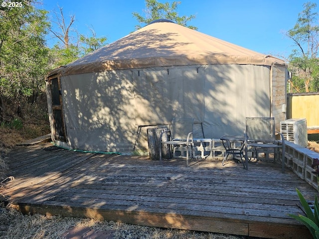 back of house featuring a deck and outdoor dining space