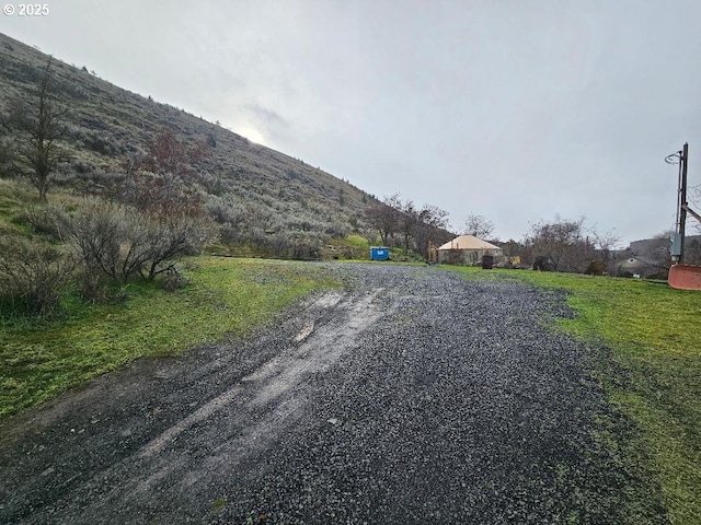view of dirt / gravel road featuring a mountain view