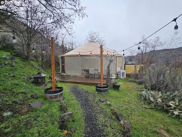 view of yard with a gazebo, a wooden deck, and a cooling unit