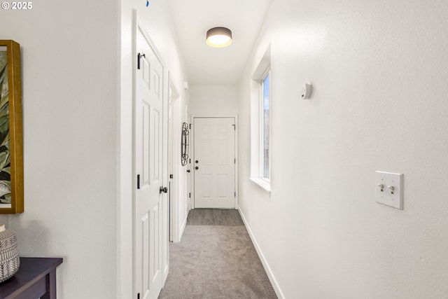 corridor featuring carpet and baseboards