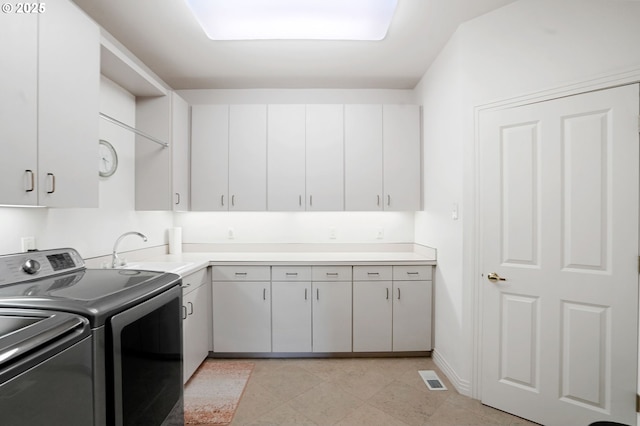 50 SE Avondale Ct, Gresham, OR 97080 - laundry room with cabinet space, washer and dryer, light tile patterned floors, and baseboards