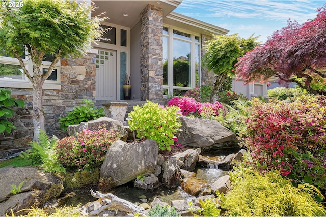 50 SE Avondale Ct, Gresham, OR 97080 - doorway to property with stone siding and a garden pond