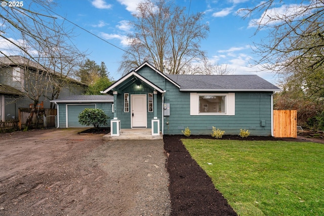 view of front of house with a garage, a shingled roof, fence, dirt driveway, and a front lawn