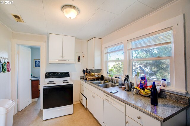 kitchen featuring white appliances, a sink, under cabinet range hood, white cabinets, and light countertops