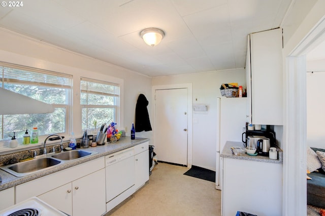 kitchen with white dishwasher, sink, and white cabinets