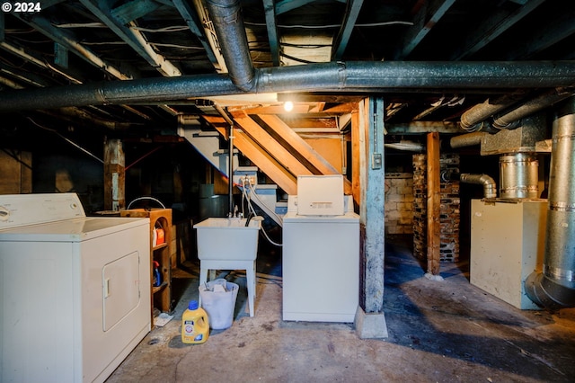 basement with sink and washing machine and dryer