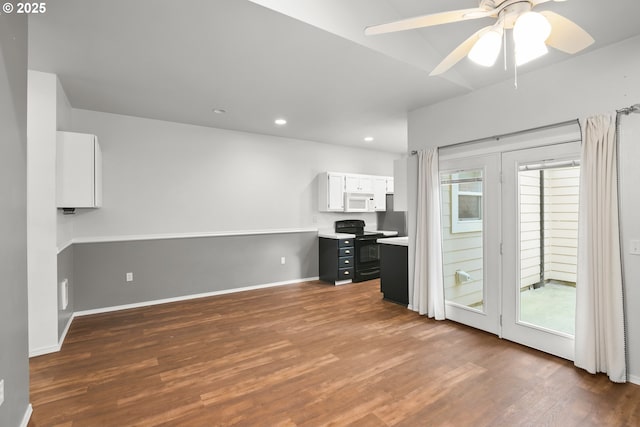 unfurnished office with dark wood-style flooring, plenty of natural light, and recessed lighting