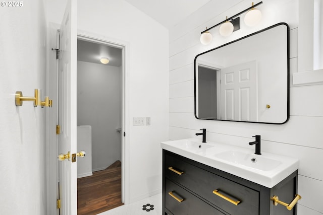bathroom with double vanity and baseboards