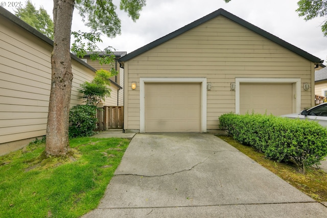 detached garage featuring fence